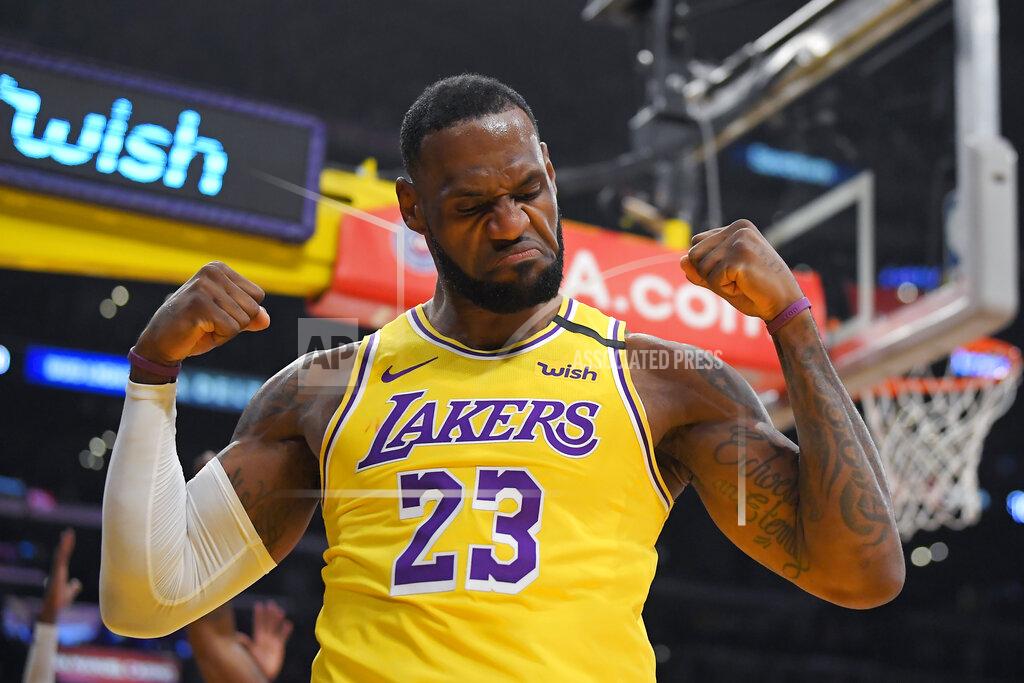Mark J. Terrill FILE - In this Jan. 7, 2020, file photo, Los Angeles Lakers forward LeBron James gestures after scoring and drawing a foul during the first half of an NBA basketball game against the New York Knicks in Los Angeles. James was announced Saturday, Dec. 26, as the winner of The Associated Press’ Male Athlete of the Year award for a record-tying fourth time.(AP Photo/Mark J. Terrill, File)