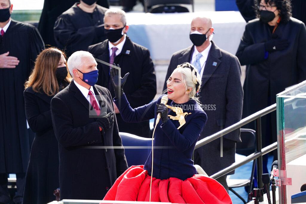 Kevin Dietsch Lady Gaga sings the National Anthem during the 59th Presidential Inauguration at the U.S. Capitol for President-elect Joe Biden in Washington, Wednesday, Jan. 20, 2021. Former Vice President Mike Pence is on left. (Kevin Dietsch/Pool Photo via AP)