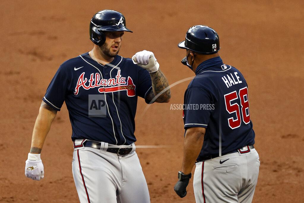 Adam Hunger Atlanta Braves' Matt Adams bumps fists with first base coach DeMarlo Hale after hitting an RBI single against the New York Mets during the first inning of a baseball game Sunday, July 26, 2020, in New York. (AP Photo/Adam Hunger)