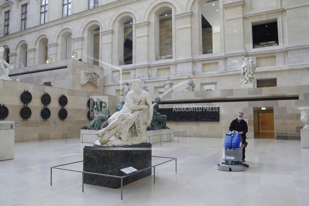 Thibault Camus A worker cleans the Marly courtyard in the Louvre museum, in Paris, Thursday, Feb. 11, 2021. Gone are the crowds' sweltering heat, the jostling for a view and the constant snapping of cameras. It's uncertain when the world's most visited museum will reopen, after being closed on Oct. 30 in line with the French government's virus measures. (AP Photo/Thibault Camus)