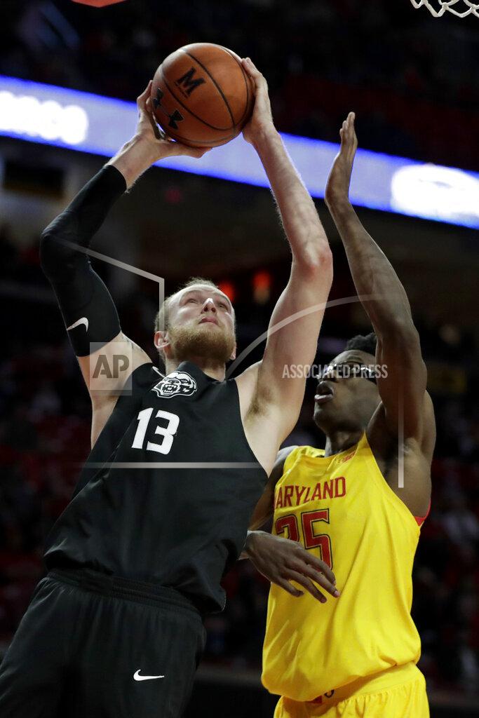 Julio Cortez Oakland center Brad Brechting (13) goes up for a shot against Maryland forward Jalen Smith (25) during the first half of an NCAA college basketball game, Saturday, Nov. 16, 2019, in College Park, Md. (AP Photo/Julio Cortez)