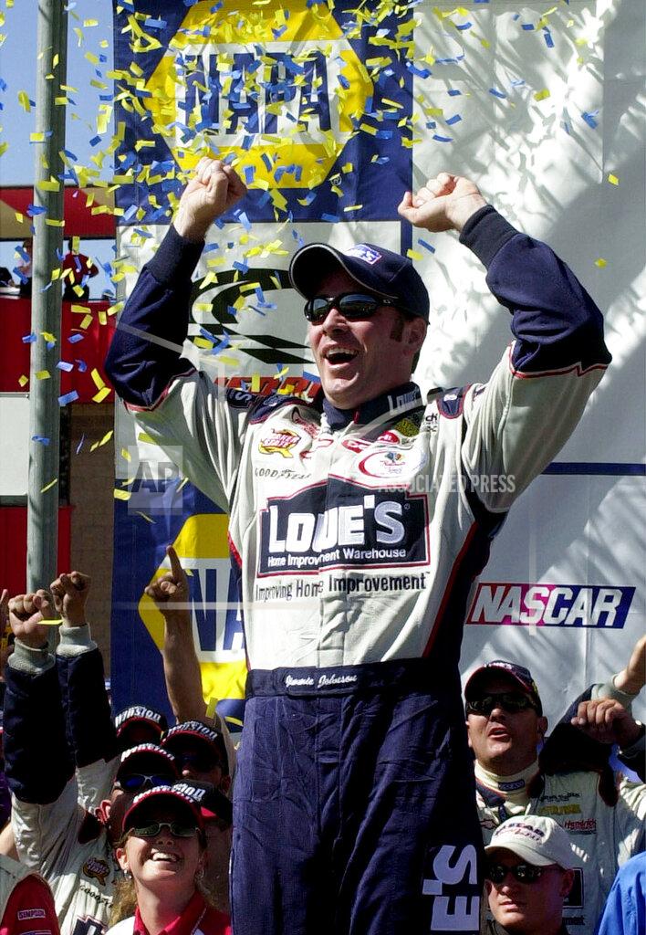 Will Lester FILE - In this April 28, 2002, file photo, Jimmie Johnson celebrates in Victory Lane after winning the NASCAR auto race at California Speedway in Fontana, Calif. When Johnson won his first NASCAR Cup Series race at Fontana 18 years ago, this famously worn-out asphalt track had a whole lot less wear and tear. So did Johnson, who is visiting his home track this weekend for the last time as a full-time driver. (AP Photo/Will Lester, File)