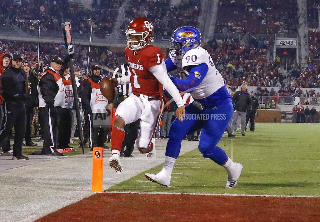 Alonzo Adams Oklahoma quarterback Kyler Murray (1) runs in for a touchdown ahead of Kansas defensive tackle Jelani Brown (90) during the second half of an NCAA college football game in Norman, Okla., Saturday, Nov. 17, 2018. Oklahoma won 55-40. (AP Photo/Alonzo Adams)