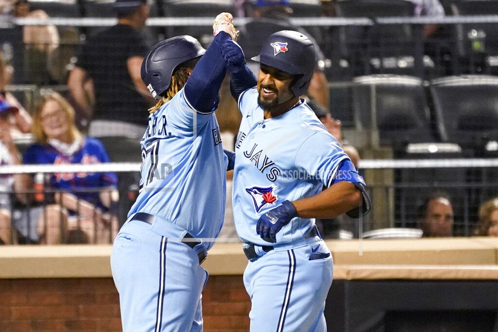 Mary Altaffer Toronto Blue Jays' Marcus Semien and Vladimir Guerrero Jr. (27) celebrate after scoring on a three-run home run by Semien during the fifth inning of the team's baseball game against the New York Mets, Saturday, July 24, 2021, in New York. (AP Photo/Mary Altaffer)