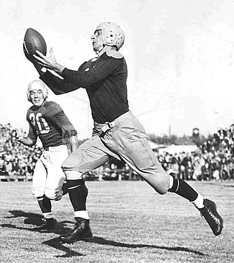 FILE - In this 1946 file photo, Green Bay Packers' Don Hutson makes a catch. When he retired after the 1945 season, Green Bay receiver Don Hutson had a record 488 catches. The next most at that time was 190. The “Alabama Antelope” had 99 career touchdown grabs, a record that stood for more than four decades. (Milwaukee Journal-Sentinel via AP)