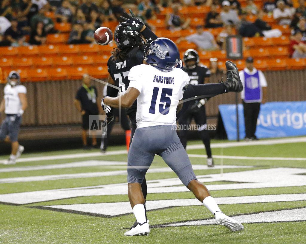 Marco Garcia Hawaii linebacker Penei Pavihi (33) breaks up an end zone pass intended for Nevada tight end Trevion Armstrong (15) during the third quarter at an NCAA college football game Saturday, Oct. 20, 2018, in Honolulu. (AP Photo/Marco Garcia)