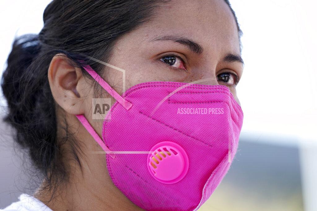 Julio Cortez Maria Cuella, a migrant from Honduras, tears up while talking about her experiences when she was caught trying to sneak into the United States and deported, Thursday, March 18, 2021, in Reynosa, Mexico. A surge of migrants on the Southwest border has the Biden administration on the defensive. The head of Homeland Security acknowledged the severity of the problem Tuesday but insisted it's under control and said he won't revive a Trump-era practice of immediately expelling teens and children. (AP Photo/Julio Cortez)