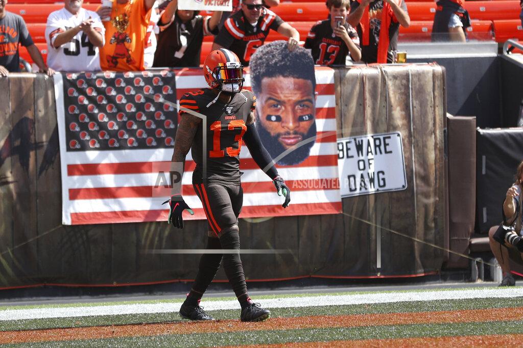 Margaret Bowles Cleveland Browns wide receiver Odell Beckham (13) stands in front of a fan holding a sign of his portrait prior to an NFL game against the Tennessee Titans, Sunday, Sept. 8, 2019, in Cleveland. (Margaret Bowles via AP)