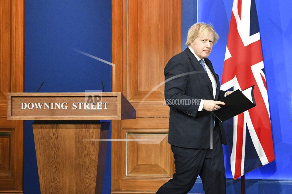 Britain's Prime Minister Boris Johnson arrives for a coronavirus briefing in Downing Street, London, Monday April 5, 2021. (Stefan Rousseau/Pool via AP)