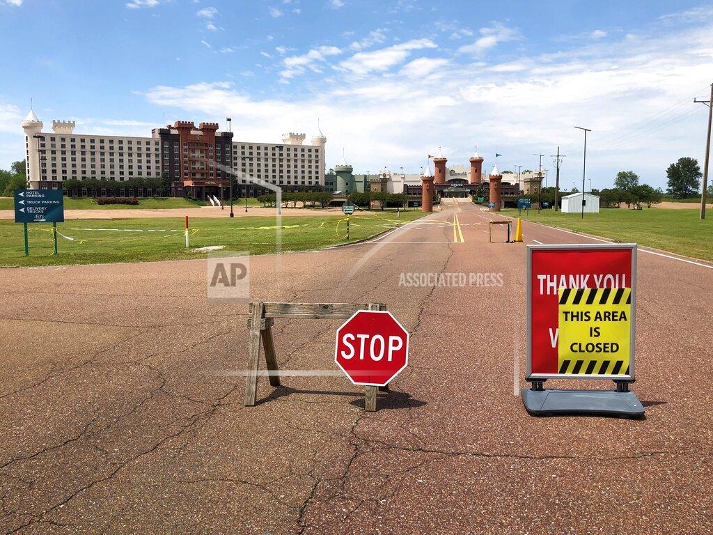 In this Monday, May 11, 2020, photo, the road leading to The Fitz Tunica Casino & Hotel is closed in Tunica, Miss. A county in the heart of the historically impoverished Mississippi Delta has been dealt a serious economic blow by the new coronavirus. Gambling halls and associated businesses in Tunica County have been shuttered for two months. That means thousands of people along the Blues Highway south of Memphis, Tennessee, are out of work. (AP Photo/Adrian Sainz)