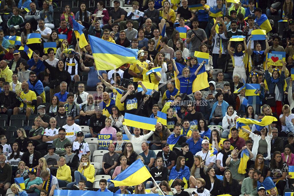 Federico Gambarini Spectators hold Ukraine flags and banners during the soccer match between Borussia Moenchengladbach and Ukraine's national soccer team at Borussia Park, Monchengladbach, Germany, Wednesday May 11, 2022. (Federico Gambarini/dpa via AP)