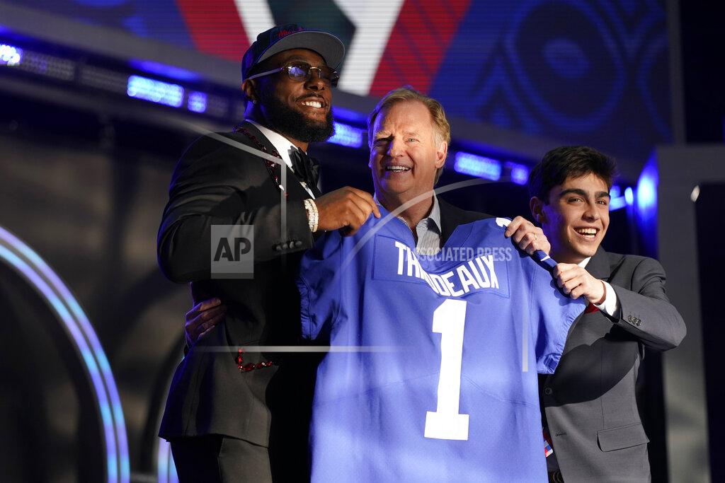 Oregon defensive end Kayvon Thibodeaux, right, stands next to with NFL Commissioner Roger Goodell after being picked by the New York Giants with the fifth pick of the NFL football draft Thursday, April 28, 2022, in Las Vegas. (AP Photo/John Locher )
