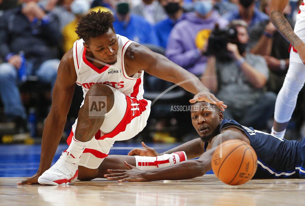 Brandon Wade Houston Rockets forward Jae'Sean Tate, left, and Dallas Mavericks forward Dorian Finney-Smith, right, vie for a loose ball during the second half of an NBA basketball game, Tuesday, Oct. 26, 2021, in Dallas. Dallas won 116-106. (AP Photo/Brandon Wade)