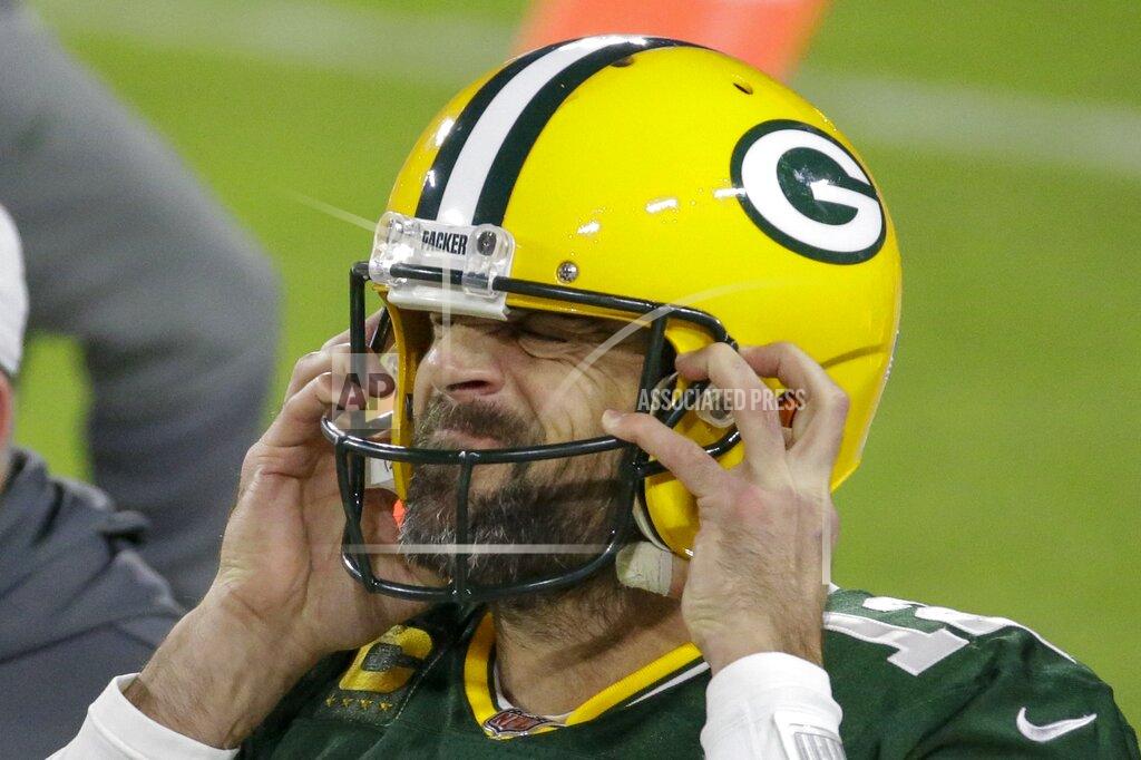Mike Roemer Green Bay Packers' Aaron Rodgers puts on his helmet during the first half of an NFL football game against the Chicago Bears Sunday, Nov. 29, 2020, in Green Bay, Wis. (AP Photo/Mike Roemer)
