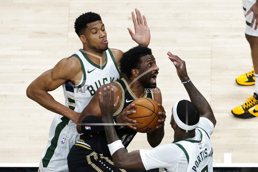 John Bazemore Atlanta Hawks forward Solomon Hill (18) drives between Milwaukee Bucks' Giannis Antetokounmpo, left, and Bobby Portis (9) during the first half of an NBA basketball game Thursday, April 15, 2021, in Atlanta. (AP Photo/John Bazemore)