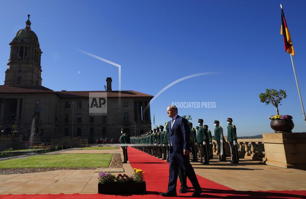 Themba Hadebe German Chancellor Olaf Scholz inspects a guard of honour during the official welcoming ceremony at the Union Building in Pretoria, South Africa, Tuesday, May 24, 2022. (AP Photo/Themba Hadebe)
