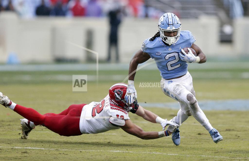 Gerry Broome North Carolina State's Brock Miller (12) dives for North Carolina's Jordon Brown (2) during the first half of an NCAA college football game in Chapel Hill, N.C., Saturday, Nov. 24, 2018. (AP Photo/Gerry Broome)