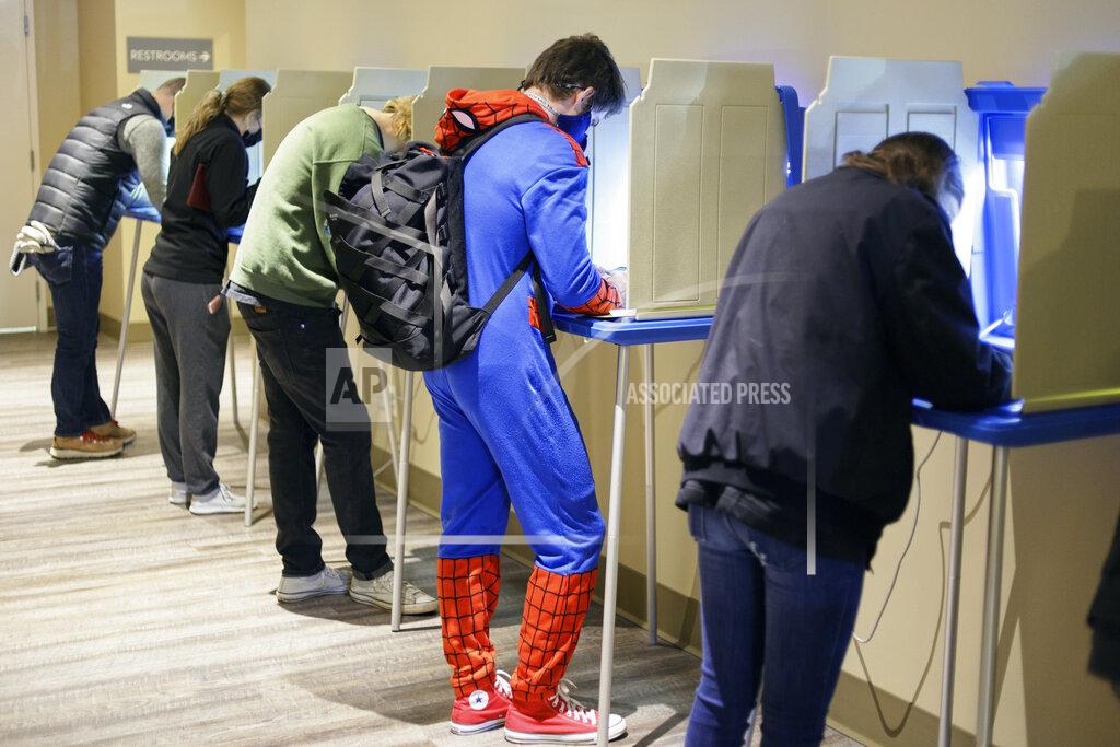 Nati Harnik Colin Buckley of Omaha wears a Spiderman suit as he votes early on Halloween, at the Douglas County Election Commision office in Omaha, Neb., Saturday, Oct. 31, 2020. (AP Photo/Nati Harnik)
