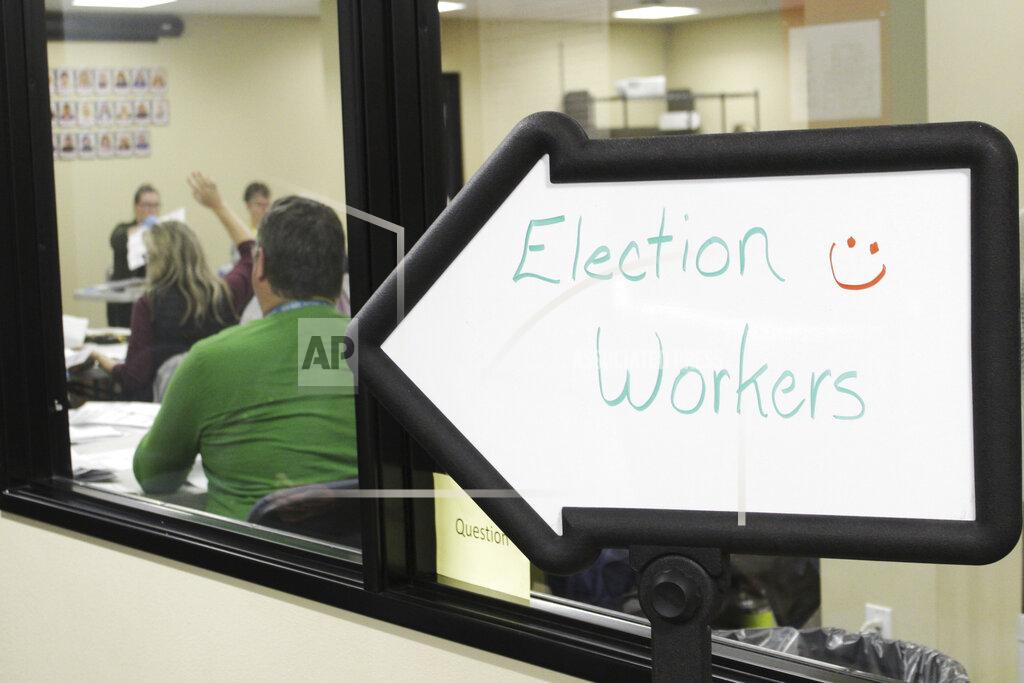 Gillian Flaccus Election workers, seen through the window, review ballots at the Clackamas County Elections office on Thursday, May 19, 2022, Oregon City, Ore. Ballots with blurry barcodes that can't be read by vote-counting machines will delay election results by weeks in a key U.S. House race in Oregon's primary. (AP Photo/Gillian Flaccus)