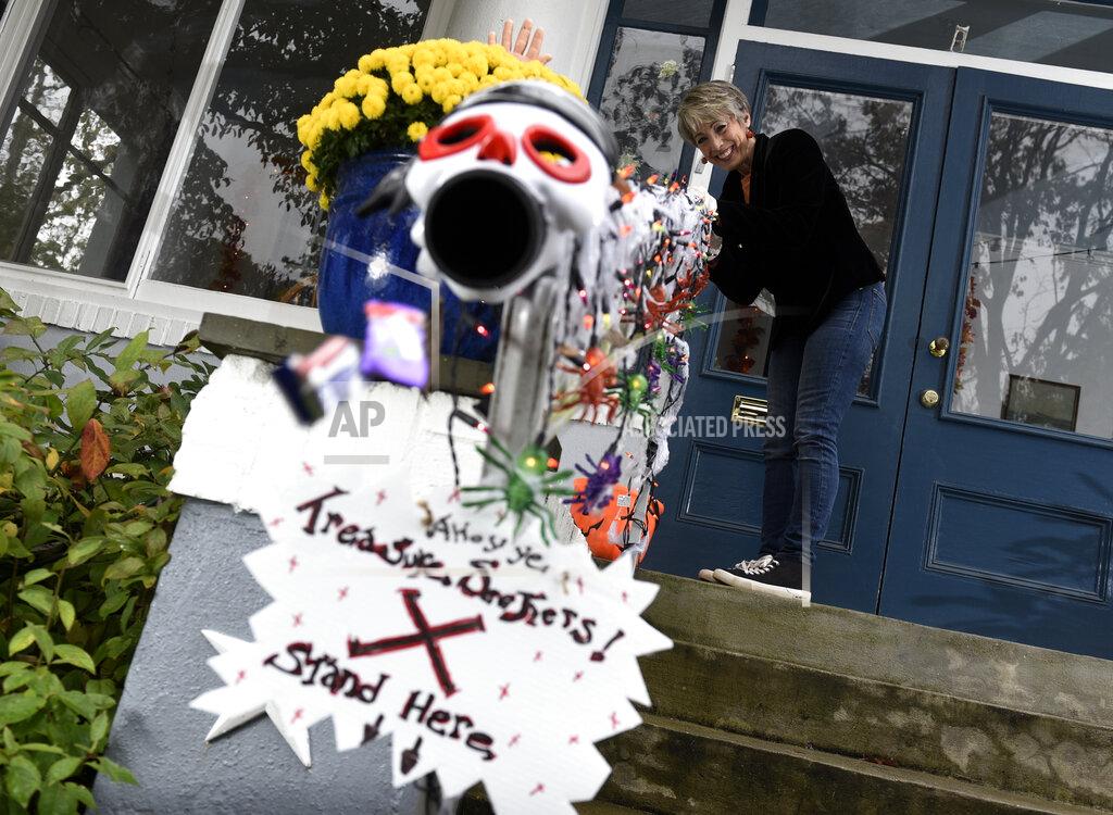 Michael Perez Carol McCarthy sends candy down the candy chute that she will use to give out treats to socially-distant trick-or-treaters on Halloween, Monday, Oct. 26, 2020, in Palmyra, N.J. (AP Photo/Michael Perez)