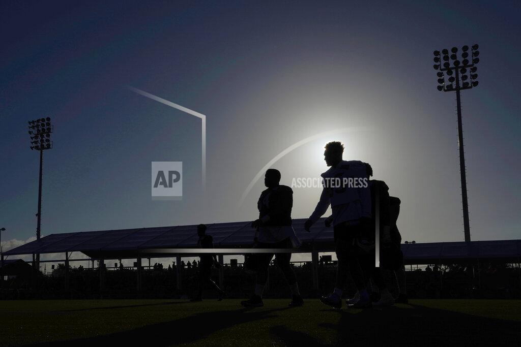 David J. Phillip Houston Texans players walk across the field before the start of an NFL football training camp practice Friday, July 29, 2022, in Houston. (AP Photo/David J. Phillip)