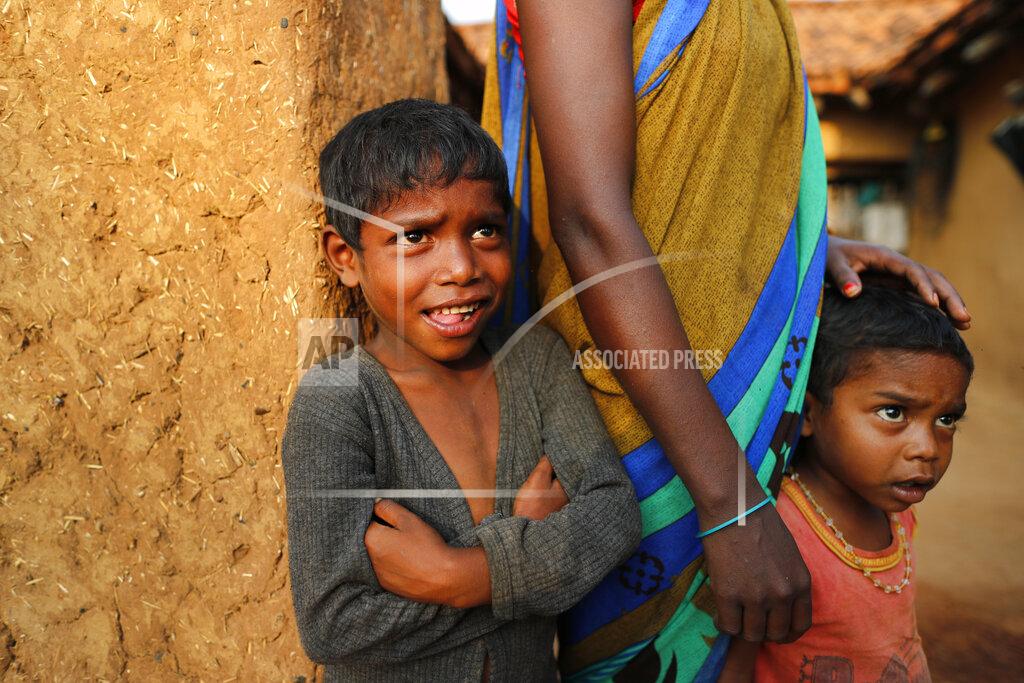 Rajesh Kumar Singh Children watch as health workers persuade elders to get vaccinated against the coronavirus at Jamsoti village, Uttar Pradesh state, India, on June 8, 2021. India's vaccination efforts are being undermined by widespread hesitancy and fear of the jabs, fueled by misinformation and mistrust. That's especially true in rural India, where two-thirds of the country’s nearly 1.4 billion people live. (AP Photo/Rajesh Kumar Singh)