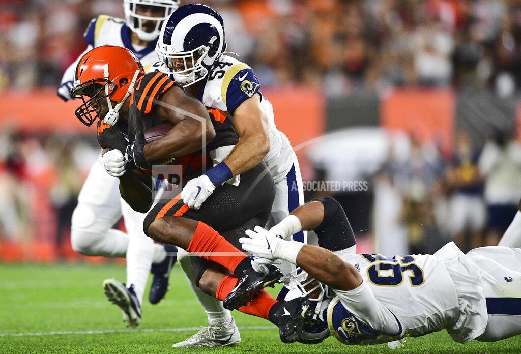 David Dermer Cleveland Browns running back Nick Chubb (24) runs for 8-yard gain under pressure from Los Angeles Rams linebacker Bryce Hager (54) and defensive tackle Aaron Donald during the first half of an NFL football game Sunday, Sept. 22, 2019, in Cleveland. (AP Photo/David Dermer)