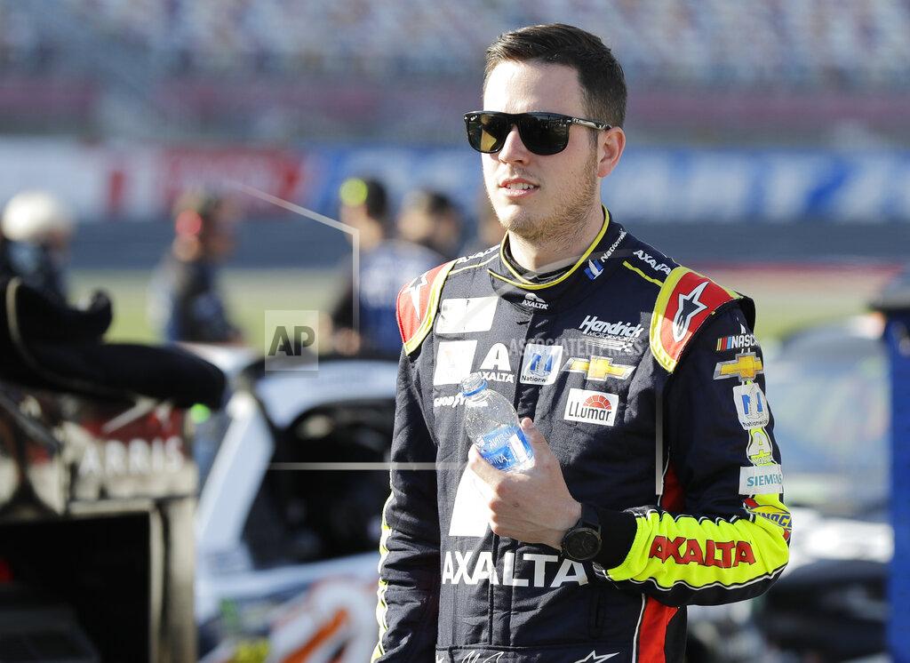 Chuck Burton William Byron walks down pit road before qualifying for Saturday's NASCAR All-Star Cup series auto race at Charlotte Motor Speedway in Concord, N.C., Friday, May 17, 2019. (AP Photo/Chuck Burton)