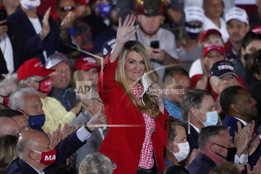 John Bazemore Sen. Kelly Loeffler, R-Ga., waves to the crowd as President Donald Trump speaks during a campaign rally at Middle Georgia Regional Airport, Friday, Oct. 16, 2020, in Macon, Ga. (AP Photo/John Bazemore)