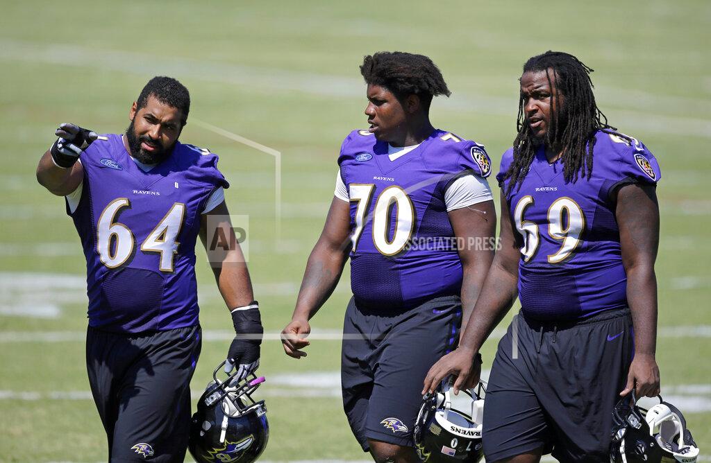 Patrick Semansky FILE - Baltimore Ravens guard John Urschel, left, speaks with teammates Robert Myers (70) and Leon Brown as they walk off the field after NFL football training camp in Owings Mills, Md., in this Wednesday, Aug. 5, 2015, file photo. John Urschel has found that a master's degree in mathematics, his stature as an accomplished author and his pending PhD at MIT isn't necessarily enough to sell young students on the benefit of crunching numbers.
What really makes him interesting to most kids is that he's a former NFL player who opted to immerse himself in math. (AP Photo/Patrick Semansky, File)