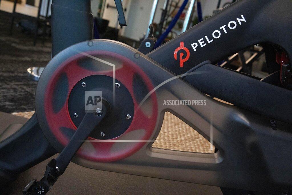 Mark Lennihan FILE - In this Sept. 26, 2019 file photo, the Peloton logo is displayed on the company's stationary bicycle in New York. In 2020, many people took to working remotely in sweatpants, hopped onto an expensive high-tech exercise bike and had their favorite restaurant dish delivered, perhaps by a driver trying to earn an extra buck and hoping not to catch the coronavirus. (AP Photo/Mark Lennihan, File)