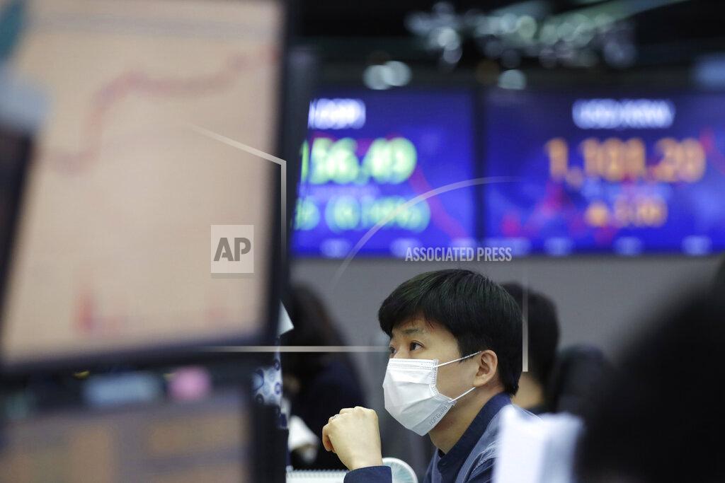Lee Jin-Man A currency trader watches computer monitors at the foreign exchange dealing room in Seoul, South Korea, Friday, Jan. 22, 2021. Asian stock markets retreated Friday after a resurgence of coronavirus infections in China and a rise in cases in Southeast Asia.(AP Photo/Lee Jin-man)