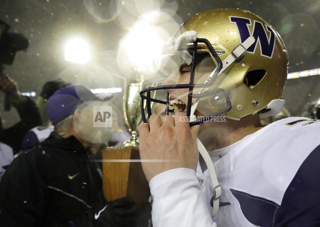 Ted S. Warren Washington quarterback Jake Browning, celebrates as snow falls after Washington beat Washington State 28-15 in an NCAA college football game Friday, Nov. 23, 2018, in Pullman, Wash. (AP Photo/Ted S. Warren)