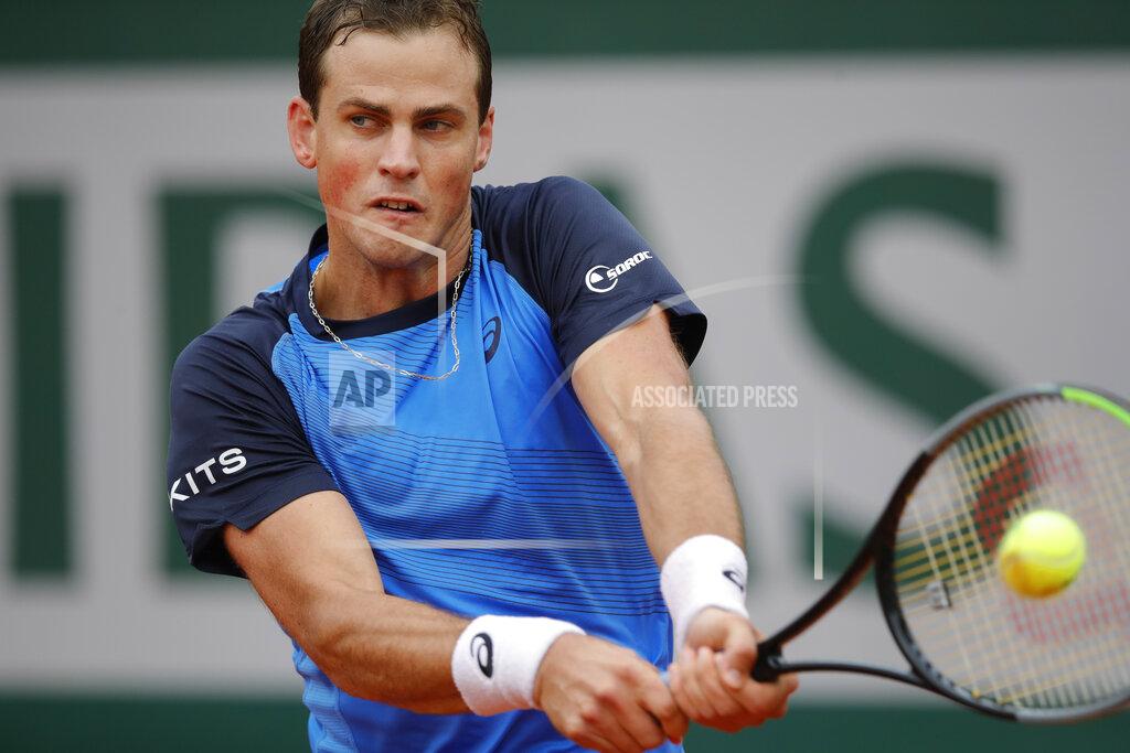 Christophe Ena Canada's Vasek Pospisil plays a shot against Italy's Matteo Berrettini in the first round match of the French Open tennis tournament at the Roland Garros stadium in Paris, France, Tuesday, Sept. 29, 2020. (AP Photo/Christophe Ena)