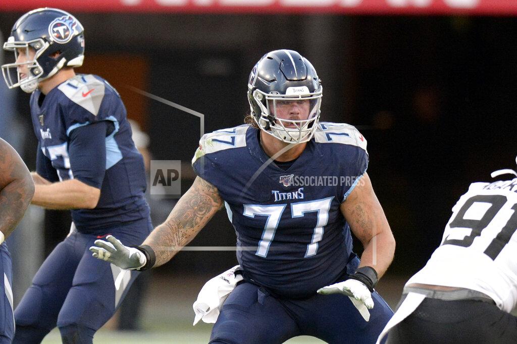 FILE - In this Nov. 24, 2019, file photo, Tennessee Titans offensive tackle Taylor Lewan (77) blocks against the Jacksonville Jaguars in the first half of an NFL football game in Nashville, Tenn. The Titans already are way ahead of where they were a year ago. That’s when they knew Lewan would sit out the first four games. Now the Titans face no suspensions with an offensive line that wants to start this season the way they finished 2019, blowing open holes for NFL rushing leader Derrick Henry.(AP Photo/Mark Zaleski, File)