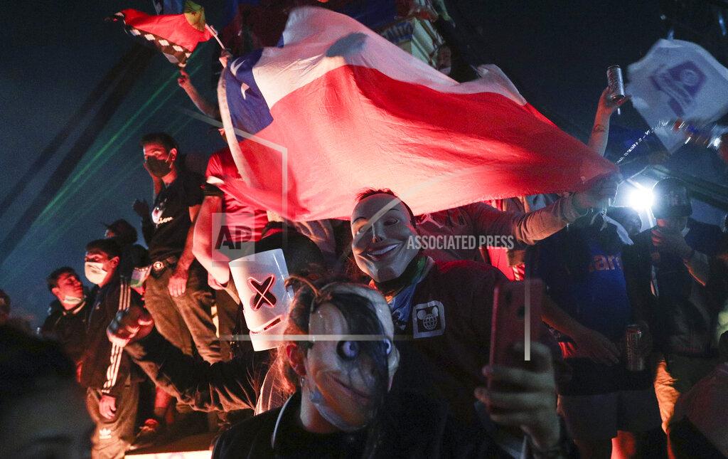 Esteban Felix People gather at Plaza Italia on the day Chileans voted in a referendum to decide whether the country should replace its 40-year-old constitution, written during the dictatorship of Gen. Augusto Pinochet, in Santiago, Chile, Sunday, Oct. 25, 2020. (AP Photo/Esteban Felix)