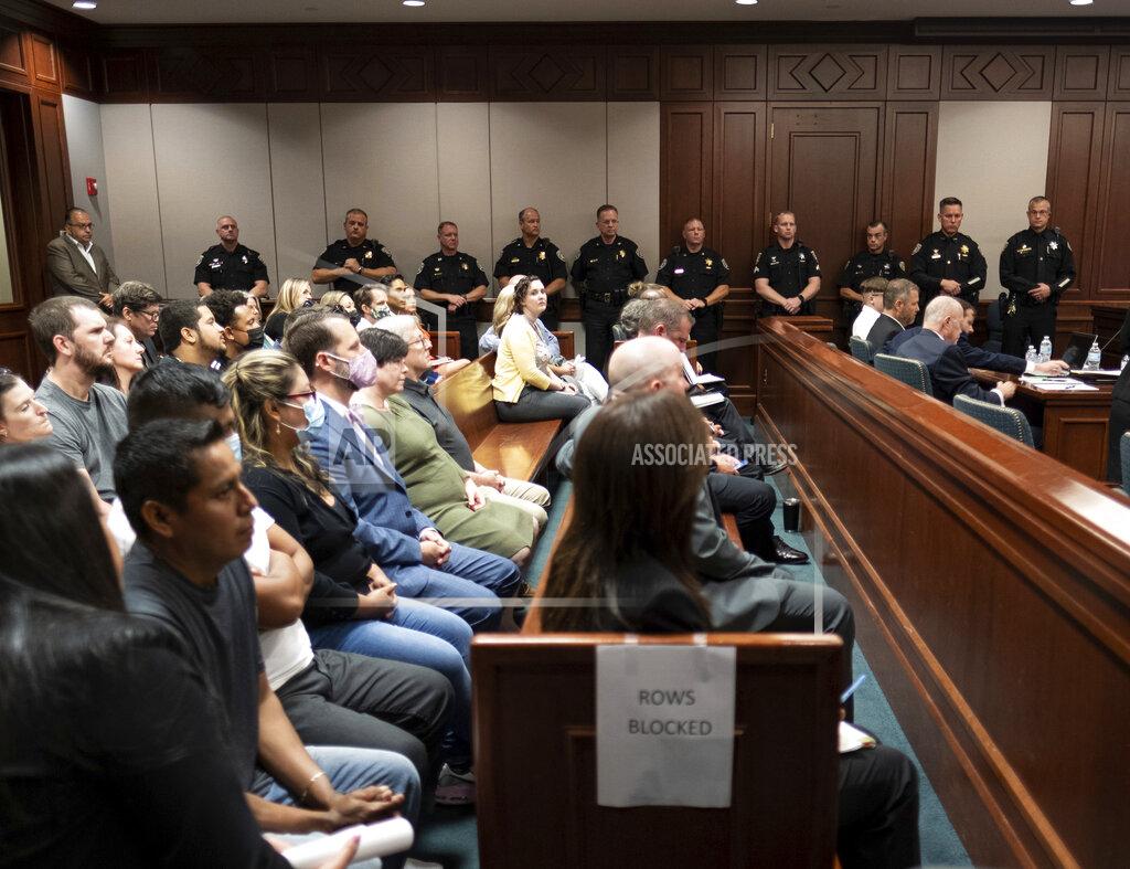 Ben Gray A heavy police presence stands in Superior Court of Cherokee County in Canton, Ga., on Tuesday, July 27, 2021, during Robert Aaron Long's plea hearing. Long, accused of killing eight people, most of them women of Asian descent, at Atlanta-area massage businesses pleaded guilty to four of the murders. He was handed four sentences of life without parole. (Ben Gray/Atlanta Journal-Constitution via AP, Pool)
