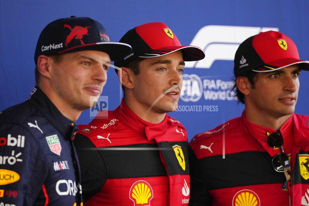 Manu Fernandez Ferrari driver Charles Leclerc of Monaco, center, pole position, is flanked by second fastest time Red Bull driver Max Verstappen of the Netherlands, left, and third fastest time Ferrari driver Carlos Sainz of Spain, pose for photographers after the qualifying session at the Barcelona Catalunya racetrack in Montmelo, Spain, Saturday, May 21, 2022. The Formula One race will be held on Sunday. (AP Photo/Manu Fernandez)