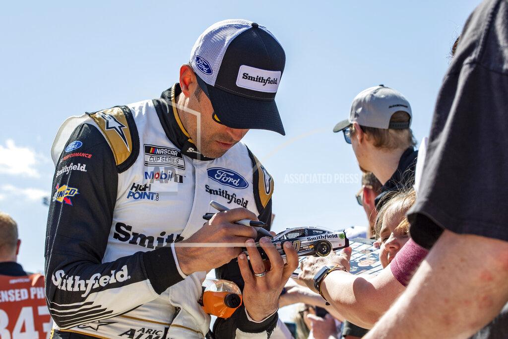 Mike Caudill Aric Almirola signs autographs before the start of a NASCAR Cup Series auto race at Richmond Raceway on Sunday, April 3, 2022, in Richmond, Va. (AP Photo/Mike Caudill)