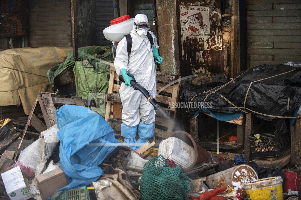 Sylvain Cherkaoui FILE - In this March 22, 2020, file photo, a municipal worker sanitizes the street of Dakar's popular Medina neighborhood after a bulldozer demolished informal shops in an effort to stop the spread of the coronavirus. Africa is bracing for a surge in coronavirus cases, but its countries are far behind in the global race for medical equipment that’s dangerously scarce. (AP Photo/Sylvain Cherkaoui, File)