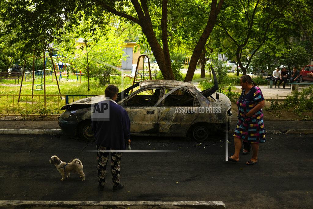 Francisco Seco Local residents look at a car burned by a bombing earlier in the day in Mykolaiv, Ukraine, Monday, May 16, 2022. (AP Photo/Francisco Seco)