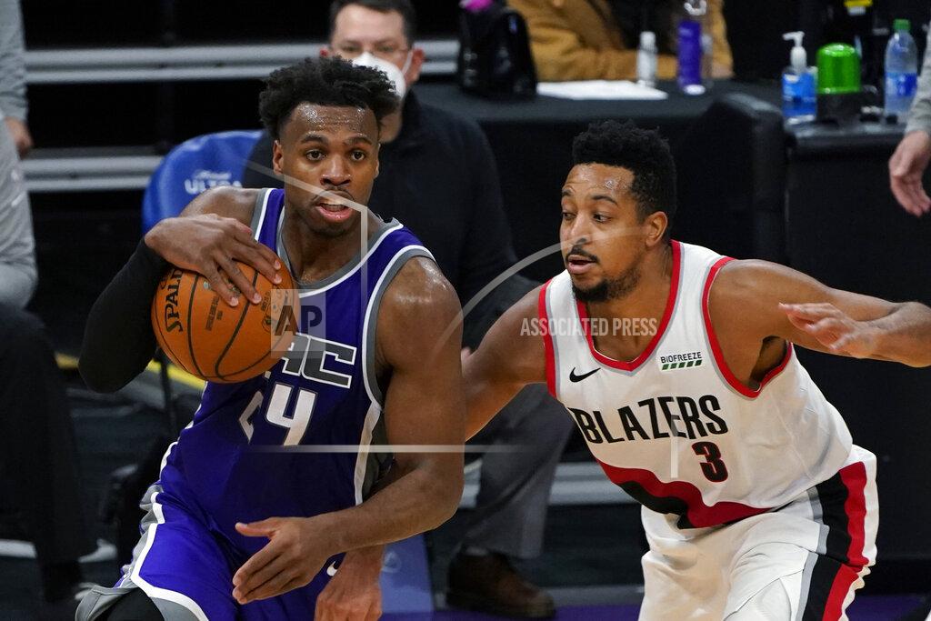 Rich Pedroncelli Sacramento Kings guard Buddy Hield, left, drives against Portland Trail Blazers guard CJ McCollum during the second half of an NBA basketball game in Sacramento, Calif., Wednesday, Jan. 13, 2021. The Trail Blazers won 132-126. (AP Photo/Rich Pedroncelli)