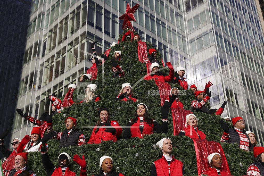 Jeenah Moon Performers on the Macy's Singing Christmas Tree float wave to spectators during the Macy's Thanksgiving Day Parade, Thursday, Nov. 24, 2022, in New York. (AP Photo/Jeenah Moon)
