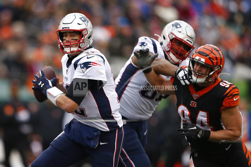 Gary Landers New England Patriots quarterback Tom Brady (12) looks to pass under pressure from Cincinnati Bengals defensive end Sam Hubbard (94) in the second half of an NFL football game, Sunday, Dec. 15, 2019, in Cincinnati. (AP Photo/Gary Landers)