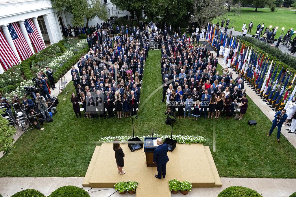 Alex Brandon In this Sept. 26, 2020, photo President Donald Trump, center, stands with Judge Amy Coney Barrett as they arrive for a news conference to announce Barrett as his nominee to the Supreme Court, in the Rose Garden at the White House in Washington. Former New Jersey Gov. Chris Christie watches from fourth row from front on far right. (AP Photo/Alex Brandon)