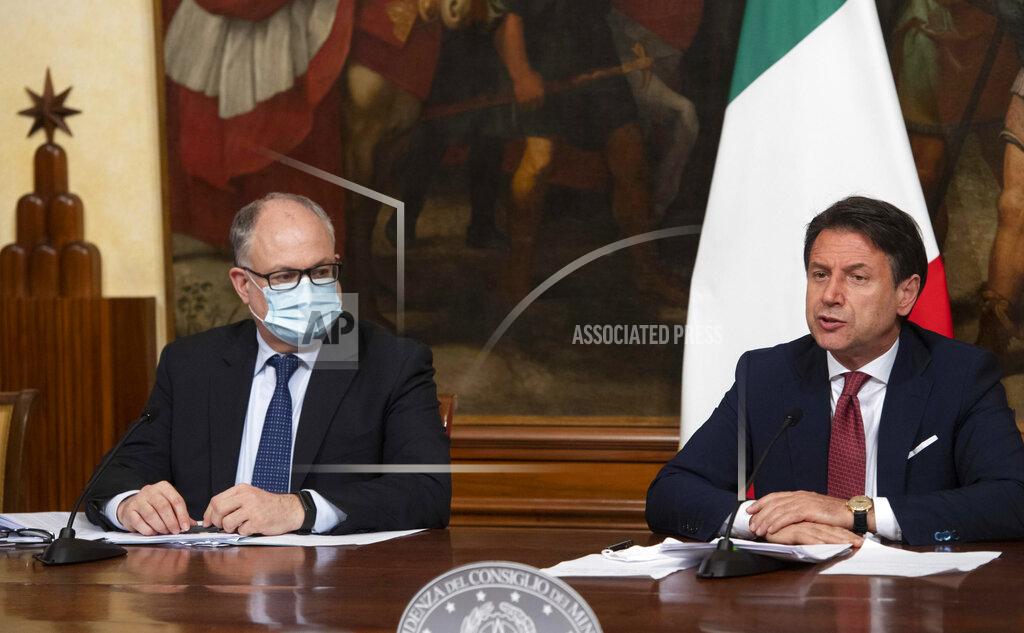 Claudio Peri Italian Prime Minister, Giuseppe Conte, right, with Economy Minister Roberto Gualtieri, left, announces the latest set of measures under another emergency decree during the coronavirus pandemic, Friday, Aug. 7, 2020, in Rome, Italy. (Claudio Peri/Pool Photo via AP)