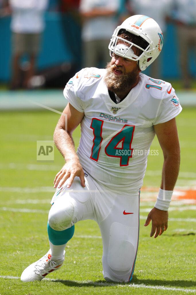 Wilfredo Lee Miami Dolphins quarterback Ryan Fitzpatrick (14) gets up after his helmet was pulled off, during the first half at an NFL football game against the Baltimore Ravens, Sunday, Sept. 8, 2019, in Miami Gardens, Fla. (AP Photo/Wilfredo Lee)