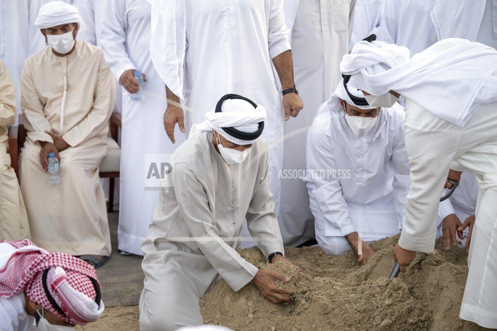 Abdulla Al Junaibi This photo made available by the Ministry of Presidential Affairs, shows Sheikh Mohamed bin Zayed Al Nahyan, Ruler of Abu Dhabi, center, and Sheikh Mansour bin Zayed Al Nahyan, UAE Deputy Prime Minister and Minister of Presidential Affairs, right, attend the burial of Sheikh Khalifa bin Zayed Al Nahyan, President of the United Arab Emirates, with other members of royal family at Al Bateen cemetery, in Abu Dhabi, Friday, May 13, 2022. (Abdulla Al Junaibi/Ministry of Presidential Affairs via AP)