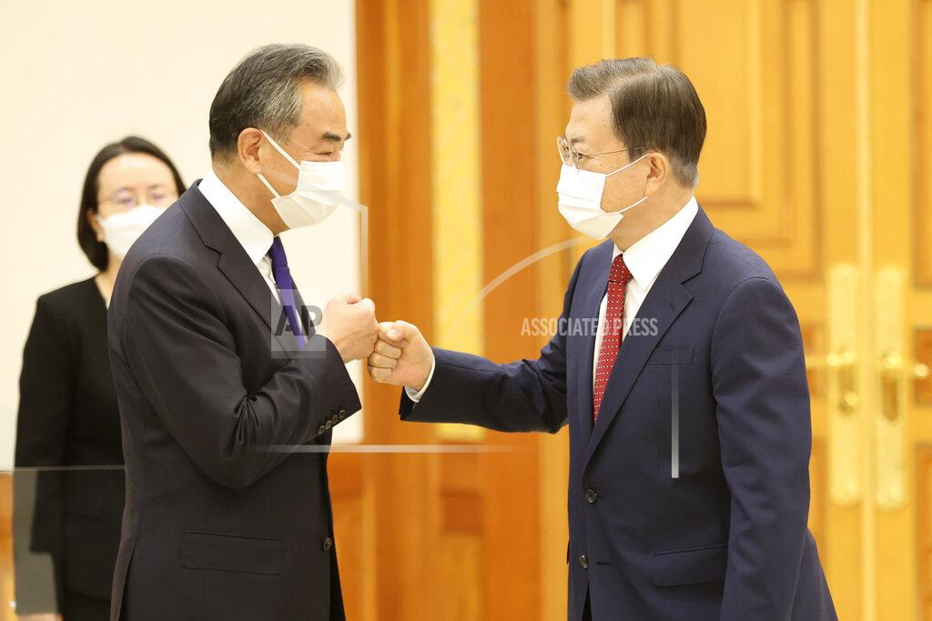 Choi Jae-Ku South Korean President Moon Jae-in, right, greets with Chinese Foreign Minister Wang Yi prior to a meeting at the presidential Blue House in Seoul, South Korea, Wednesday, Sept. 15, 2021. Wang was to hold a meeting with his South Korean counterpart for talks expected to focus on North Korea and other regional security issues. (Choi Jae-ku/Yonhap via AP)