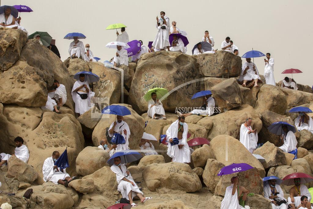 Amr Nabil Muslim pilgrims pray on top of the rocky hill known as the Mountain of Mercy, on the Plain of Arafat, beside inscriptions which were left by pilgrims from previous years, during the annual hajj pilgrimage, near the holy city of Mecca, Saudi Arabia, Monday, July 19, 2021. The coronavirus has taken its toll on the hajj for a second year running. What once drew some 2.5 million Muslims from all walks of life from across the globe, the hajj pilgrimage is now almost unrecognizable in scale. (AP Photo/Amr Nabil)